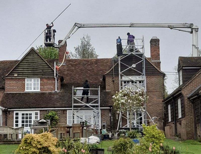The Roof Moss Cleaners using cherry picker and scaffolding to clean roof safely and professionally in Crawley Down, West Sussex